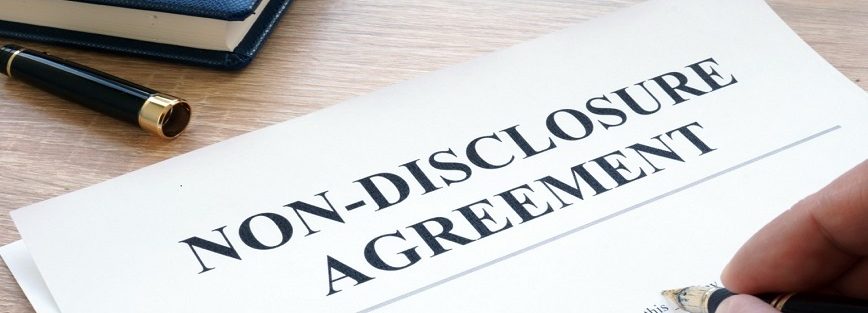 Man is filling in Non-Disclosure Agreement NDA.